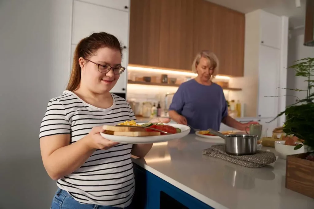 NDIS participant preparing meal with support worker