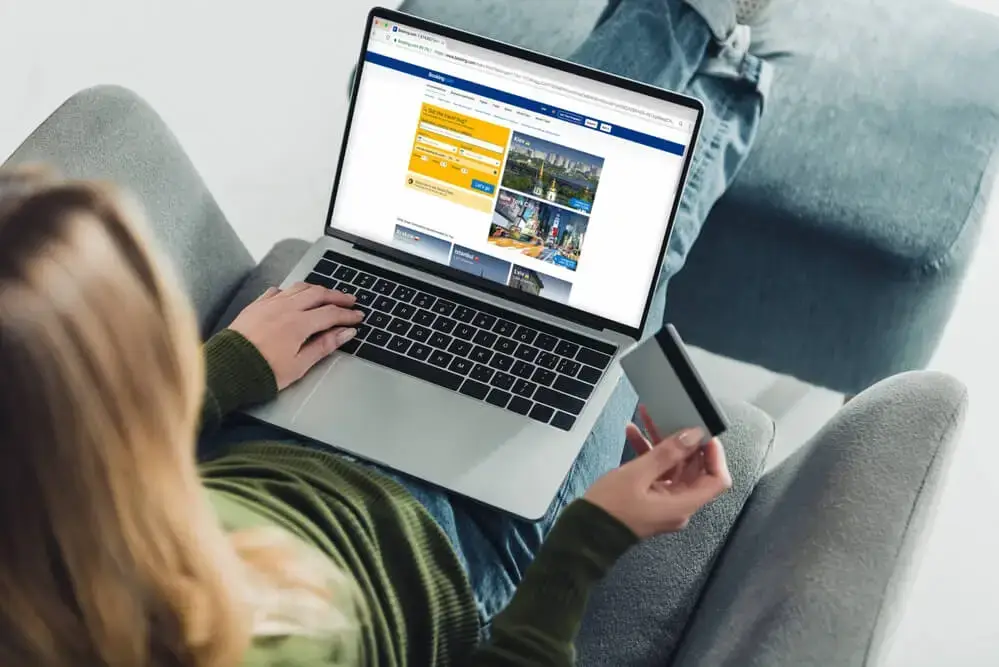 A person's hand pressing a "SKYROCKET SALES" button on a laptop with charts in the background, illustrating website conversion optimisation