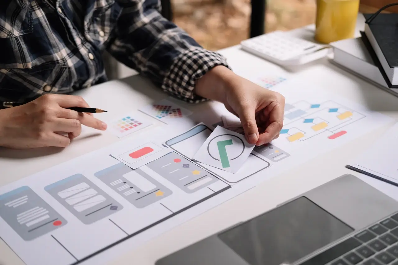 A diverse set of tools, from a simple calculator and pencil to a sophisticated laptop, representing the varying costs of a landing page