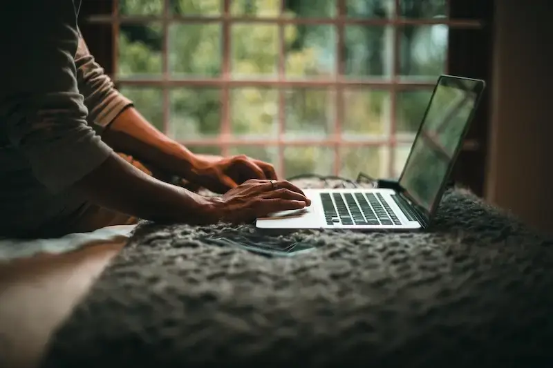 A diverse group of people using laptops and phones, illustrating various ways to drive organic traffic to a website