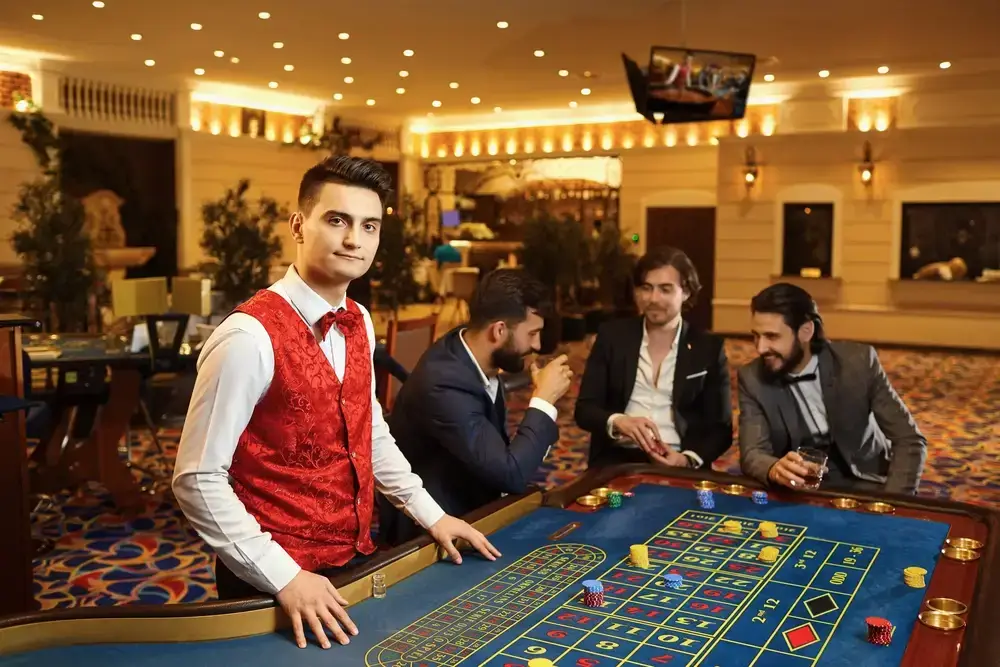 a dealer looks directly at the camera while three poker players chat among themselves, appearing happy and believing they have control over their luck, a common phenomenon known as gambler's fallacy.