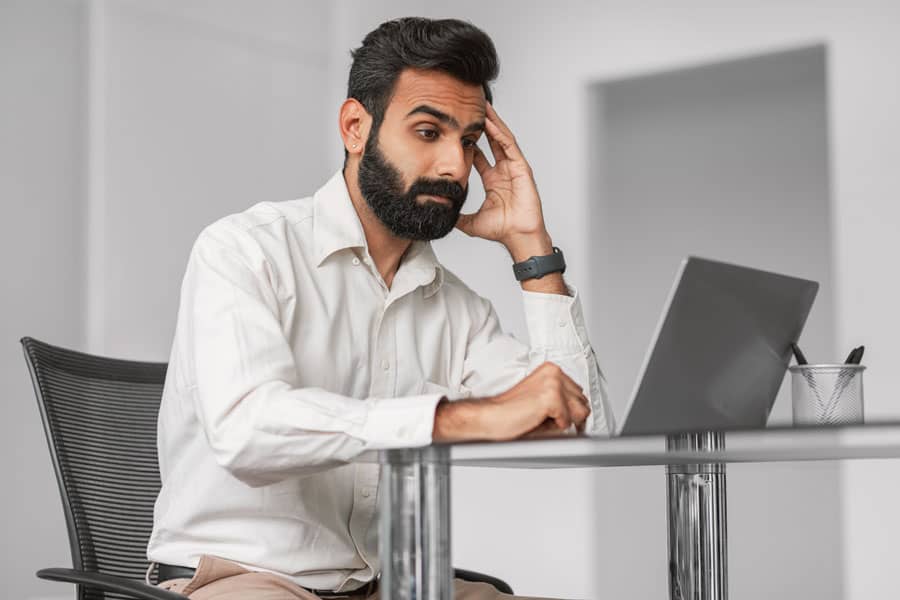 pensive indian businessman at laptop having proble 2023 11 27 05 16 20 utc